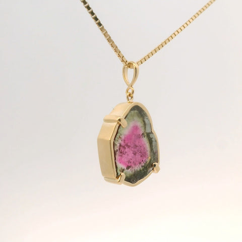 gold pendant with pink and green tourmaline stone, side view