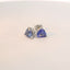Earrings featuring triangle blue stones from a front view