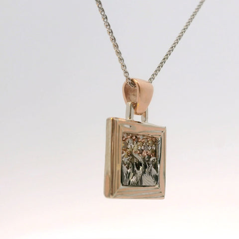 close-up of the rose gold and silver pendant