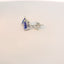 Close-up view of earrings with triangle blue stones