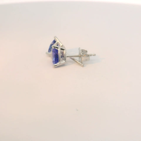 Close-up view of earrings with triangle blue stones