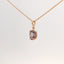 rose gold pendant featuring a purple gemstone, front view