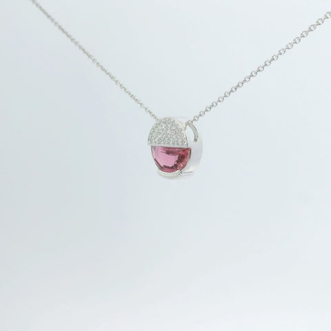 Necklace with a pink gemstone pendant viewed at an angle